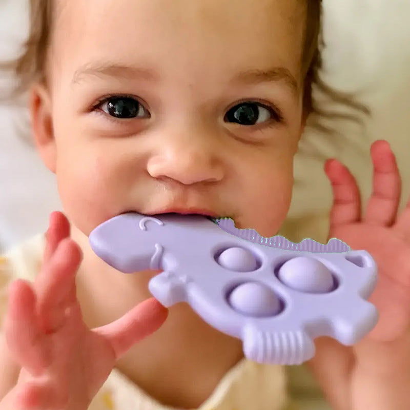 Pop Teething Toy - Kiddi Craze - baby using the purple dinosaur pop teether